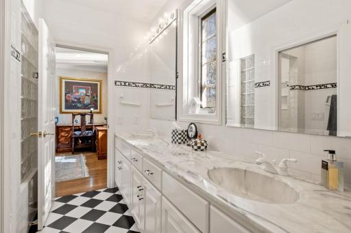 Double sinks and mirrors. Fun black and white tile floor.