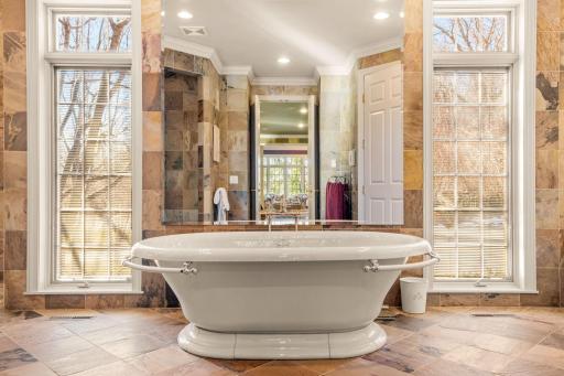 Luxurious soaking tub in the primary bathroom
