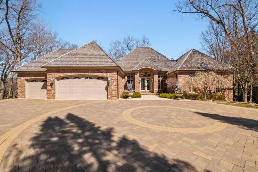 Beautiful and spacious turnaround paver driveway and parking.