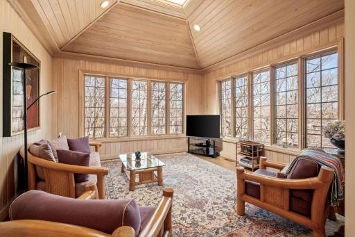 Warm and inviting four season room feels like a treehouse in the summer! Great views of the lake across Interlachen.