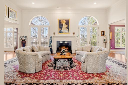 Cozy conversation space in this exquisite living room. The windows offer natural light and art.