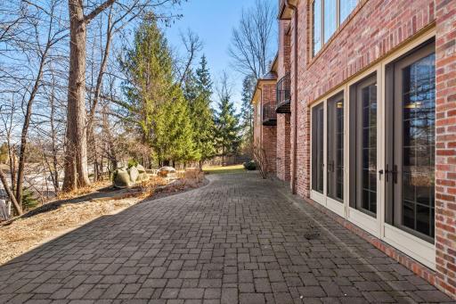 Paver patio spans the back of the house for all the french doors to have access.