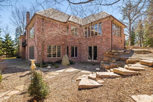 Rear of the home shows the well thought out landscaping. Minnesota rock and stone were used to create a space of minimal maintenance.