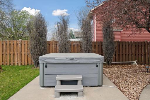 Wood privacy fence surrounds the backyard. Hot tub to stay with home!