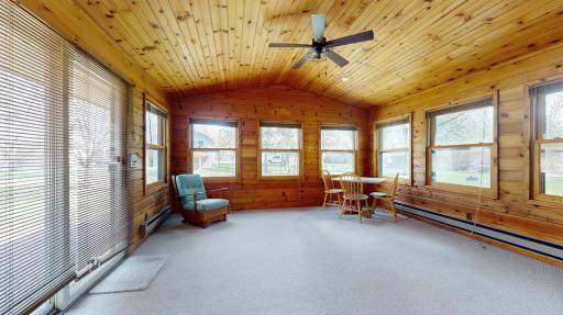 The main floor family room exudes rustic charm with its wood walls and vaulted ceilings. Step out onto the deck for outdoor dining.