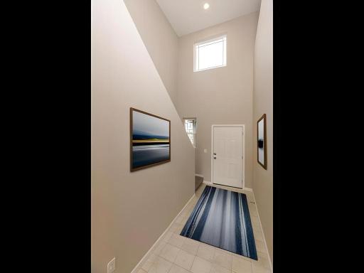 Photo taken of different home with similar plan & finishes virtually staged. Spacious two story foyer.