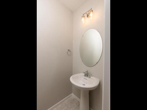 Photo taken of different home with similar plan & finishes. Main level half bath.