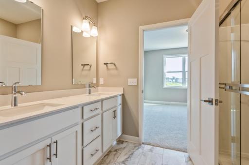(*Photo of similar home, actual homes colors and finishes will vary) The double vanity in the owner's bath provides plenty of space for everyone to get ready in the morning