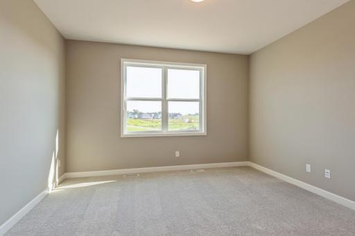 (*Photo of similar home, actual homes colors and finishes will vary) The spacious owner's suite that connects to a private en-suite
