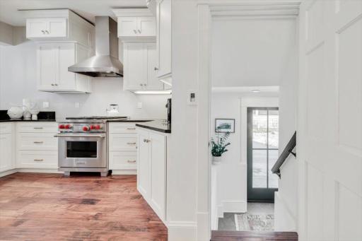View into kitchen from formal dining and side door entry