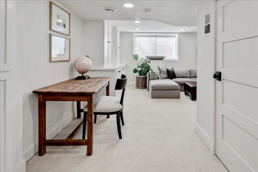 Amusement room featuring built-ins and oversized egress lookout window