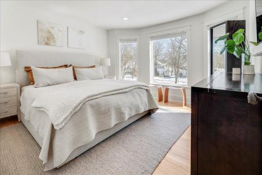 Upper level primary bedroom with bay window facing east