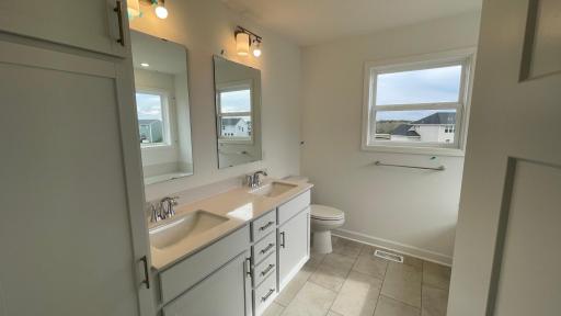 The en-suite owners bath has double sinks and a large tub