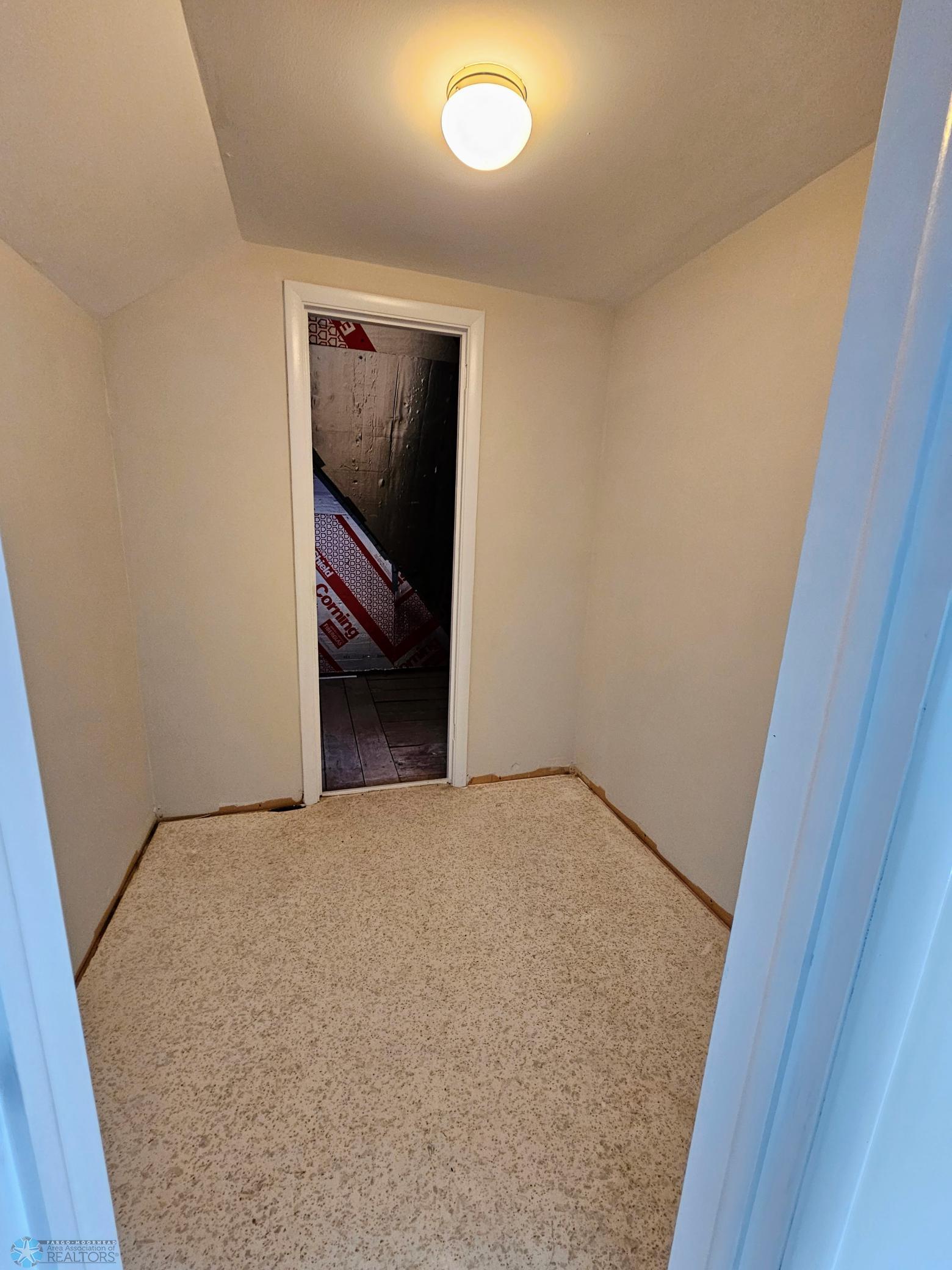Primary WIC #2 with view of unfinished attic space