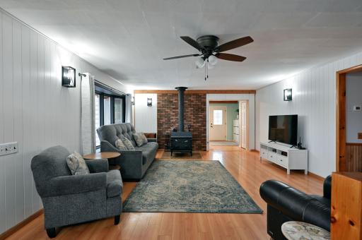 The spacious living room has a wood burning stove.
