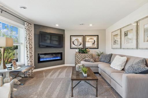 (Photo of a decorated model, actual homes finishes will vary) Cozy up next to the fireplace.