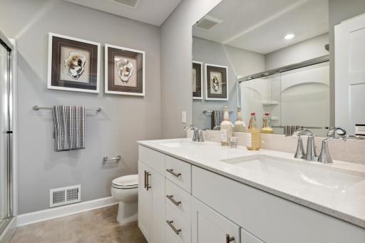 (Photo of a decorated model, actual homes finishes will vary) Dual sinks in the owner's bathroom provide plenty of room for each of the homeowners.