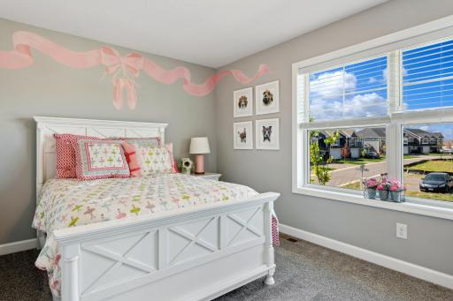 (Photo of a decorated model, actual homes finishes will vary) This home's two secondary bedrooms provide personal space for younger family members or overnight guests.