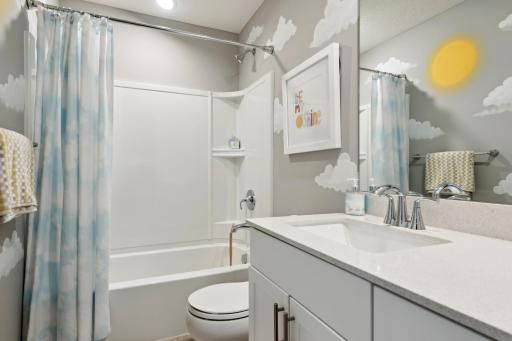 (Photo of a decorated model, actual homes finishes will vary) The spacious secondary bath.