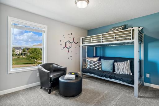 (Photo of a decorated model, actual homes finishes will vary) This secondary bedroom provides more space and includes a desirable walk-in closet.