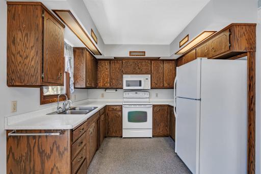 The kitchen features ample cabinetry as well as built-in lighting.