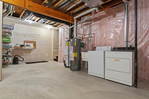 Large Mechanical Room has Additional Washer/Dryer and Stairway up to the Garage