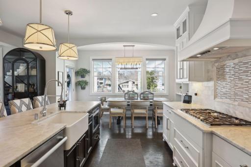 Bright open informal dining room has built-in and entry to back yard