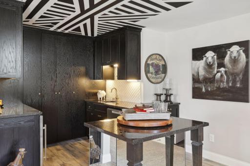 Wet bar adds flair to gatherings with full wall of cabinetry