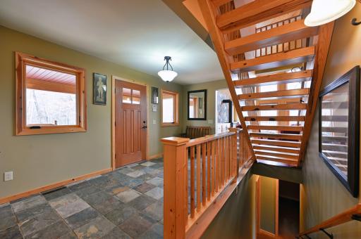 Stairs lead to the lower walkout level as well as the loft above.