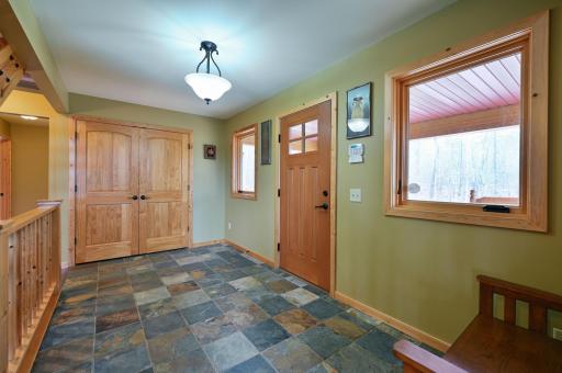 The entry to the main home has a large coat closet and slate floors.