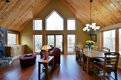 The main floor living spaces have vaulted plank ceilings and wood floors throughout.