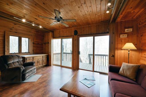 The living space has double sliding glass doors and a ceiling fan.