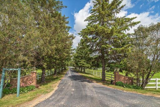 A tree-lined drive with white fencing greets you as you enter the property off 165th Street. The driveway was just paved and sealcoated this year!