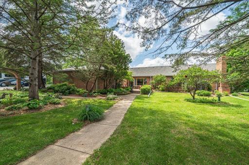 The yard has trees, perennial gardens, walkways, archways and more, all creating a scenic and welcoming atmosphere befitting this horse-lovers property!