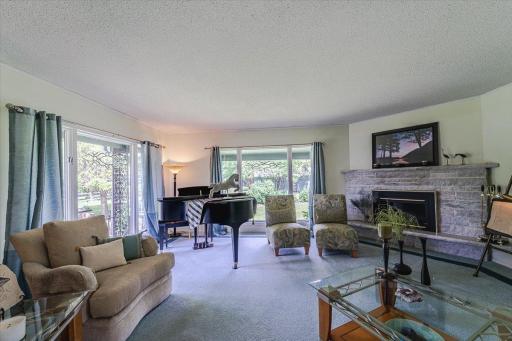 The family room has Andersen picture windows that take in views of the property, gardens and stable, and a corner gas fireplace.