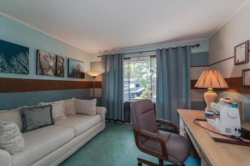 This is one of three upper level bedrooms, used as a hobby/den space. This room overlooks the front of the home and has an Andersen picture window.