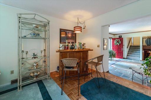 This bar space has a parquay floor and lies between the family room and dining room.