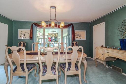 The formal dining room connects to the kitchen, family room/bar, and overlooks the pool room. A walk-in pantry lies in the corner.
