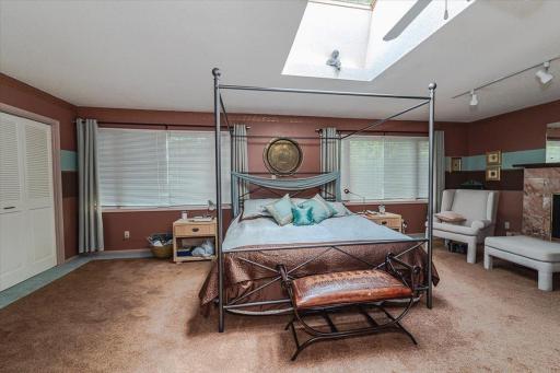 The primary suite is enormous, being a double-sized room with a gas fireplace, skylight window, and attached private full bath.