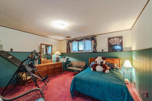 This large lower level bedroom has a lookout window.