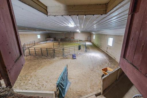 View of the indoor riding riding arena from the hayloft. The indoor riding arena has a limestone base floor, and is heated and insulated.