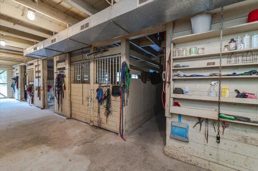 This hallway leads to the tack room and exterior.