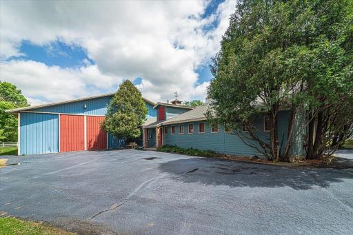 The 60'x32' barn is heated via a separate furnace, and has 9 box stalls with rubber mats, a hayloft that holds 700 bales, and a 17'x12' tack room with a half bath. The barn is connected to the indoor riding arena. Oh....and there's a cupola!!