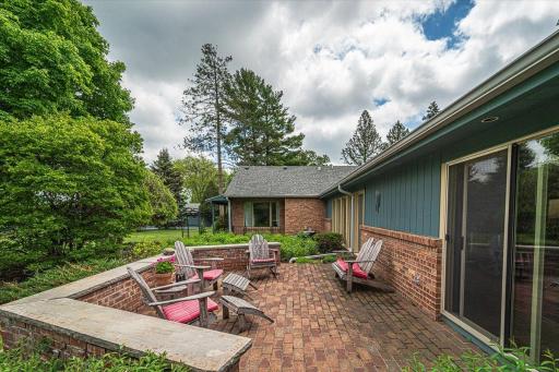 A close up of the paver patio deck off the pool room, with a half-wall that tucks you in and gives you that glorious country estate feel.