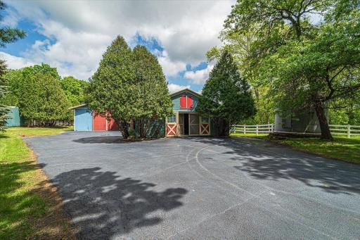 The 60'x32' heated barn has 9 box stalls, a hayloft, tack room, half bath, and adjoined 110' x 70' heated indoor riding arena.