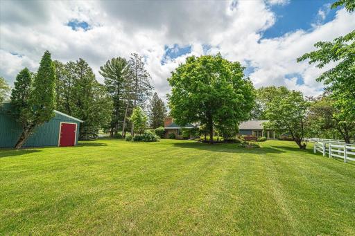 The backyard setting (north side) of the home, with the stallion barn to the left.