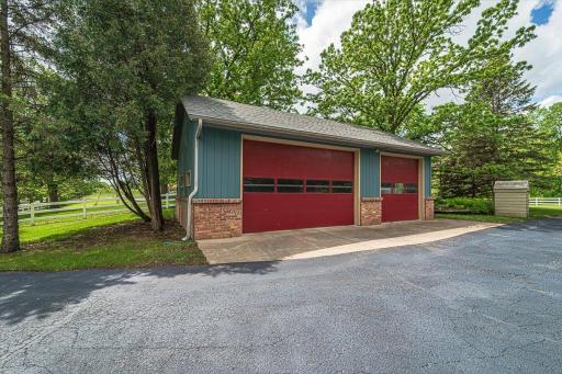 This detached 3-Car outbuilding garage has 10â doors and a rear door tall enough to accommodate a semi tractor.