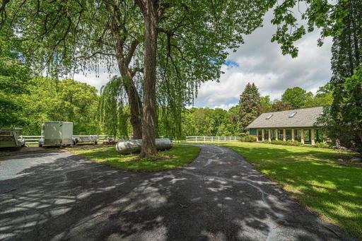 There is space to store your trailers near the outbuilding, for convenient loading and unloading. The pool room is shown in the right of photo.