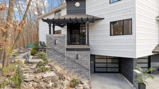 Under the front porch is the basement entrance, and covered outdoor storage closet.