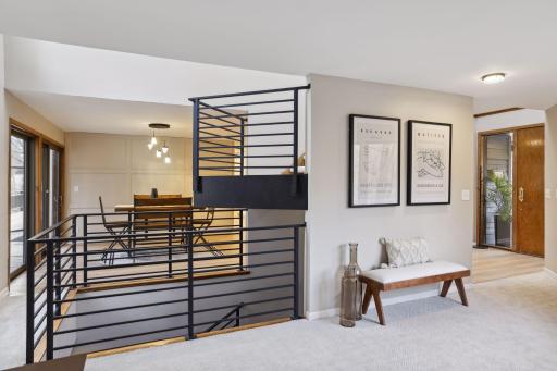 A cat walk has been added over the open stairs to access formal dining from the living room.